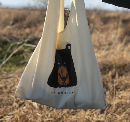A Babincho illustrated tote bag photographed outdoors